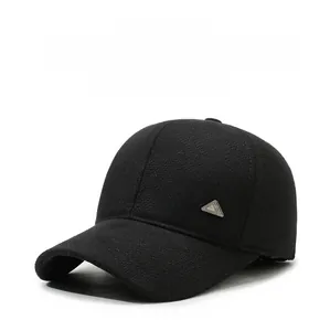 Close-up of black wool baseball cap with ear protection and side metal logo detail