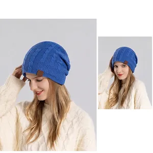 Winter cable knit beanie in blue with fleece lining and leather patch for outdoor warmth