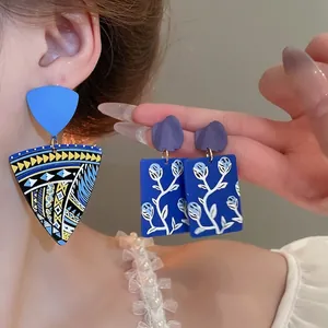 Ethnic geometric drop earrings with blue floral patterns and purple abstract studs