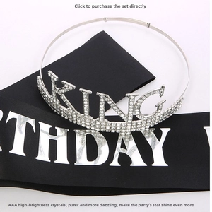 Detail of silver rhinestone King crown and black Birthday satin sash for party