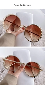 Close-up of round pearl-embellished metal sunglasses with double brown gradient lenses