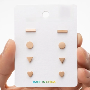 Close-up of four-pair rose gold stainless steel earring set in geometric shapes