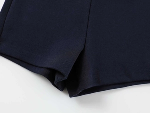 Detailed macro view of navy blue high-waist yoga shorts showing seamless flatlock stitching