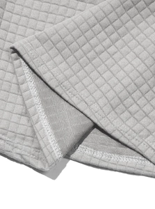 Detail shot of the grey quilted waffle pattern and double-stitched hem on the sweatshirt