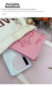 Pink faux leather travel notebook with butterfly and To Mom engraving next to phone