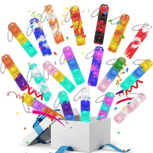 Rainbow pop-it fidget toy keychains bursting out of a gift box on a white background
