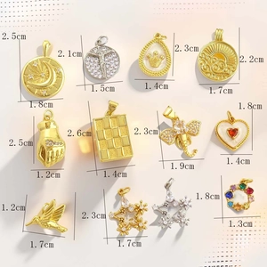 Detailed flat lay of assorted 18k gold plated heart, moon and crown charms for DIY jewelry