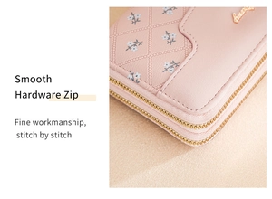 Detail of pink leather wallet showing smooth golden hardware zip and fine stitching