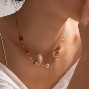 Colorful floral beaded necklace with gold metal chain on a model for a trendy look