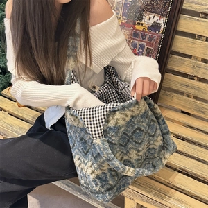 Close-up of the plush shoulder bag interior featuring black and white checkered lining