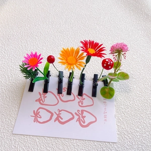 Close-up of colorful flower and mushroom hair clips on a strawberry display card