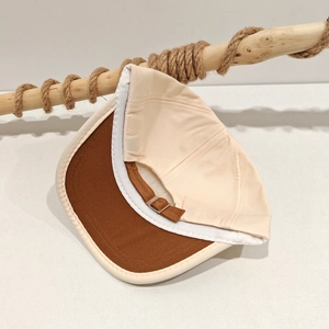 Detail view of cotton baseball cap interior with sweatband and adjustable metal buckle