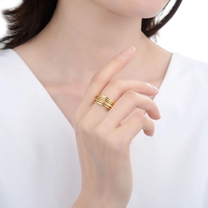 Minimalist multi-layer gold wrap ring with adjustable open design on female model finger