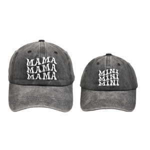 Detail of MAMA and MINI matching baseball caps in washed charcoal grey cotton