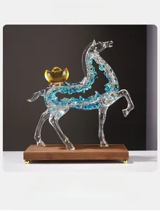 Detail of horse resin statue with gold leaf and blue crystal on dark wood base