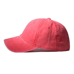 Side view of washed red baseball cap with retro distressed texture and six-panel design