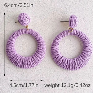 Macro detail of purple raffia hoop earrings with size measurements 6.4cm by 4.5cm