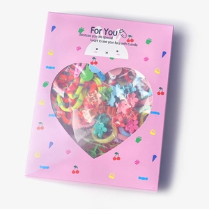 Pink heart window gift box showing colorful hair ties and flower clips for girls