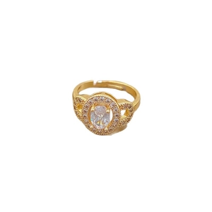 Adjustable gold ring with oval cubic zirconia and pave diamonds on white background