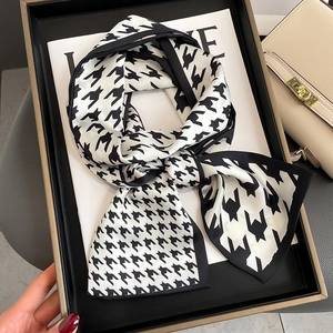 Classic black and white houndstooth silk scarf elegantly displayed in a premium black gift box