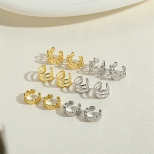 Detail view of gold and silver grid ear cuff set in various minimalist patterns