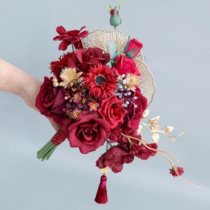 Traditional Chinese bridal wedding bouquet with red roses, gold fans and festive tassels