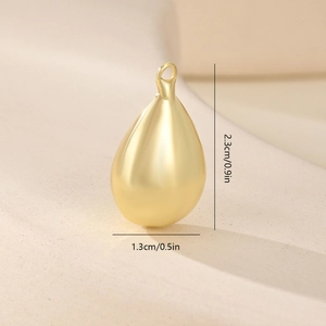 Macro view of matte gold teardrop pendant showing dimensions for DIY jewelry making