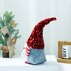 Christmas gnome doll with red sequin hat and gray felt body for home holiday desk decoration