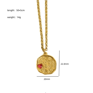 Golden stainless steel necklace featuring a vintage Medusa pendant with a red heart stone