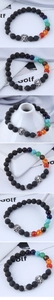 Macro detail of black volcanic stone beads with silver lion head and chakra accents