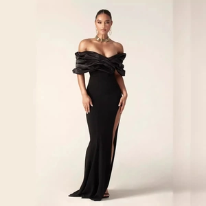Elegant off-shoulder black evening dress with high slit and pleated satin finish