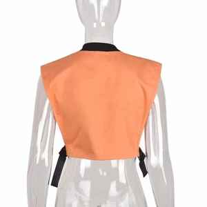 Detail view of orange sports vest with black contrast collar and back drawstring ties