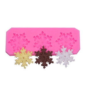 Detailed macro view of pink silicone snowflake mold with three distinct crystal patterns