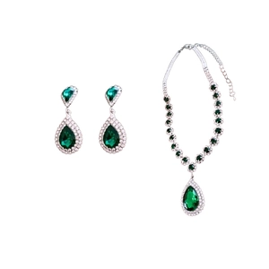 Elegant silver jewelry set with teardrop green gemstones and sparkling diamond accents