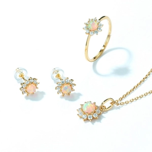 Macro shot of gold-plated sunflower jewelry set featuring round opal stones and small diamonds