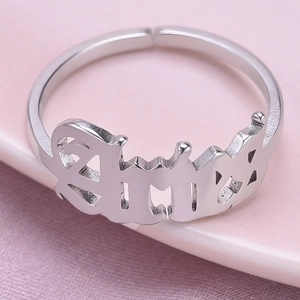 Close-up of adjustable silver stainless steel ring featuring gothic letter carving