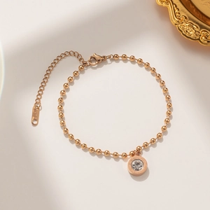 Golden titanium steel bead bracelet with Roman numeral pendant and sparkling diamond crystal