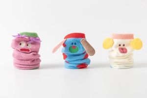 Close-up of cute cartoon thermal socks featuring 3D ears and soft coral fleece texture