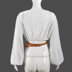 Detail view showing white pleated texture fabric and brown leather belt on jacket back