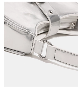 Detail shot of silver metallic handbag with white trim and polished hardware