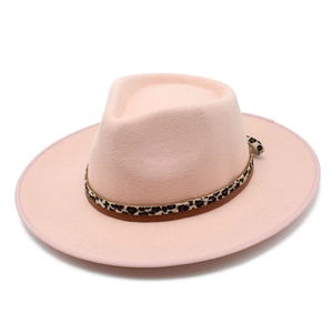 Detail of a pink wool fedora hat featuring leopard print ribbon and leather trim detail