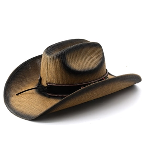 Close-up of woven straw western cowboy hat featuring black gradient brim and ethnic beaded band