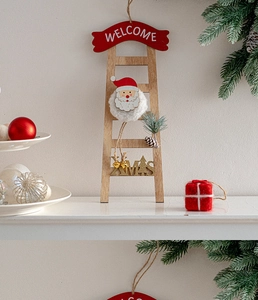 Detail of wooden Christmas ladder hanger with plush Santa head and Welcome XMAS lettering