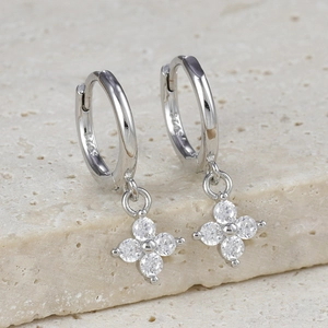 Detailed macro view of S925 sterling silver hoop earrings with zircon flower charms