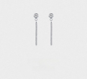 Macro shot of long s925 silver dangle earrings with micro-paved sparkling cubic zirconia