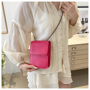 Detail of rose red mini crossbody phone bag with black metal chain and flap closure