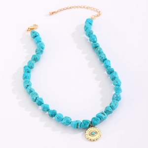 Detail of bohemian turquoise beaded necklace with golden evil eye charm and lobster clasp