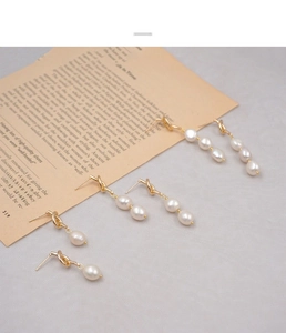 Detail of French vintage knot earrings with white freshwater pearls in three length options