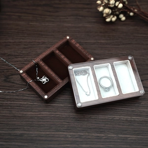 Close-up of black walnut jewelry box with three slots and transparent glass lid