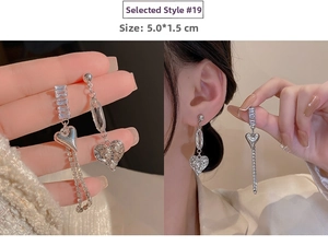 Detail view of silver heart tassel earrings showing 5.0x1.5cm size and ear-worn look